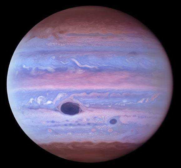 This ultraviolet image of Jupiter was created from data captured on January 11, 2017 using the Hubble Wide Field Camera 3.  The big red spot and the red spot Jr. absorb ultraviolet radiation from the sun and therefore appear dark in this view.  Image Credit: NASA / ESA / NOIRLab / NSF / AURA / Wong et al.  / from Pater et al.  / Mr. Zamani.