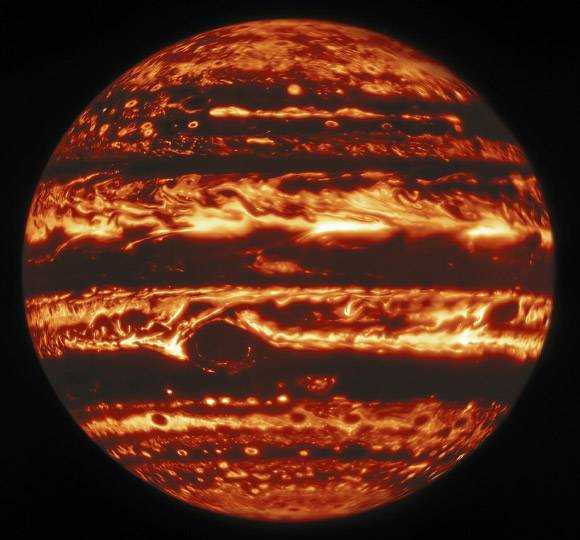 This infrared view of Jupiter was created from data captured on January 11, 2017 with the Gemini North Telescope's near infrared imager.  In the image, the warmer areas appear bright, including four large hot spots that appear in a row just north of the equator.  South of the equator, the large, oval-shaped, cloud-covered red patch appears dark.  Image Credit: Gemini Observatory / NOIRLab / NSF / AURA / Wong et al.  / from Pater et al.  / Mr. Zamani.